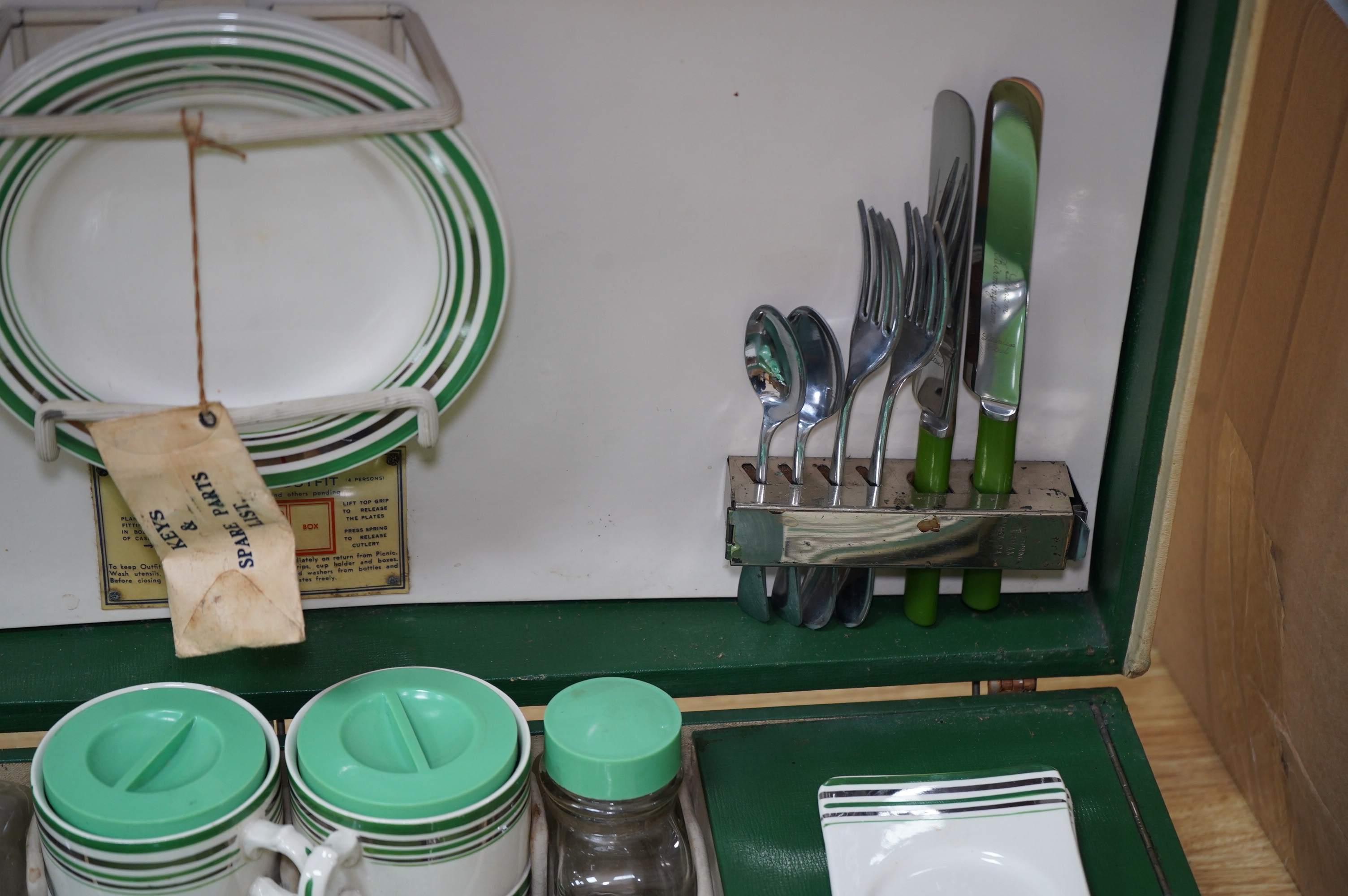 An Art Deco, c.1930's cased picnic set with flasks, cutlery, plates and cups. Condition - poor